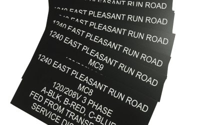black plastic with white letters engraved signs